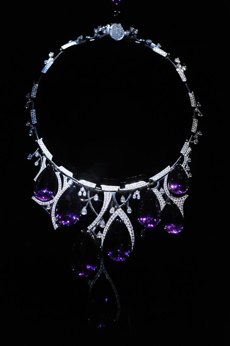 A diamond and amethyst necklace on black velvet